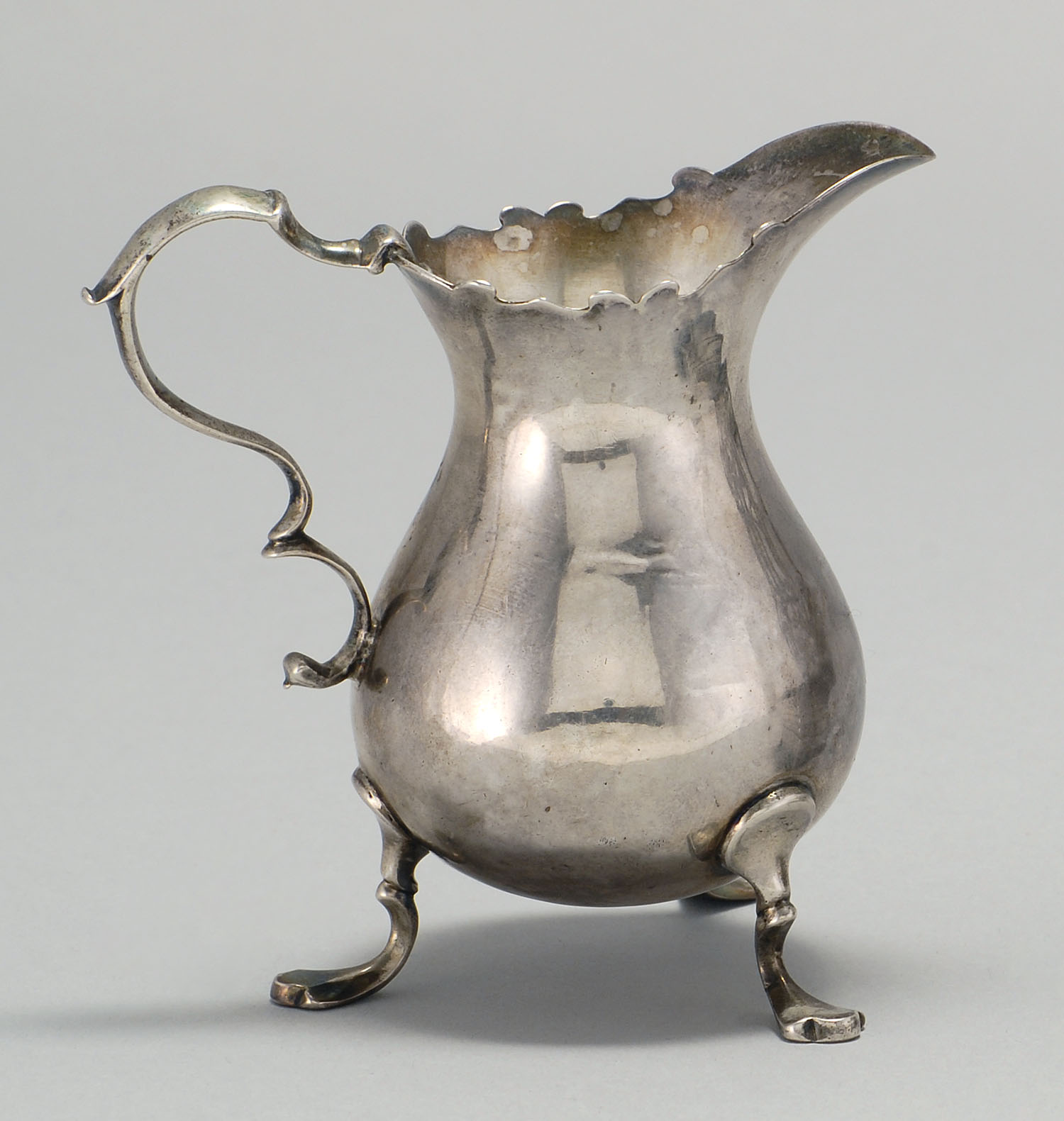 Appraisal: ENGLISH SILVER CREAMER BY BENJAMIN WEST London Beautiful scrolled handle