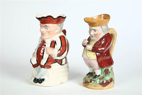 Appraisal: TWO ENGLISH TOBY PITCHERS Standing gentleman packing Tobacco h And