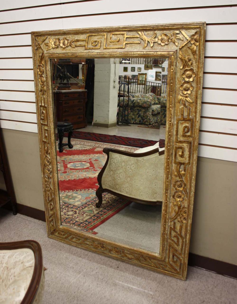 Appraisal: LARGE RECTANGULAR WALL MIRROR having a relief-carved and parcel-gilt wood