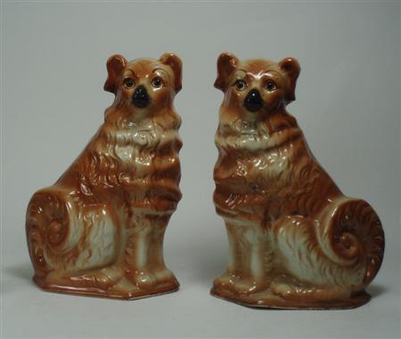 Appraisal: A pair of Bo'ness type pottery dogs sitting with russet