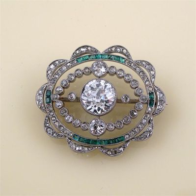 Appraisal: A Belle Epoque diamond and emerald brooch the centre circular