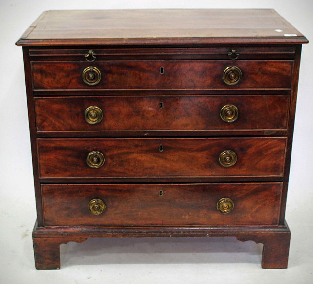 Appraisal: A GEORGE III MAHOGANY CHEST of four long graduated drawers