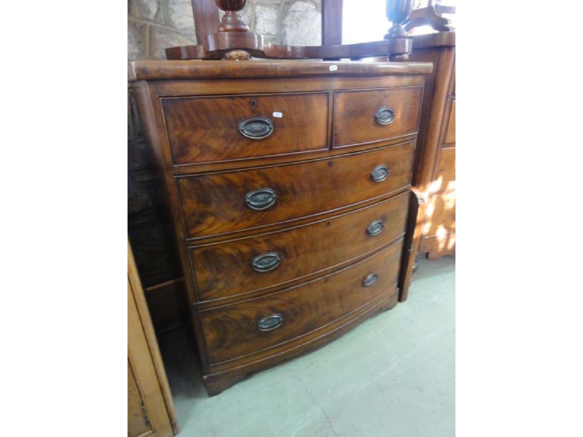 Appraisal: An early th century mahogany bow fronted bedroom chest of