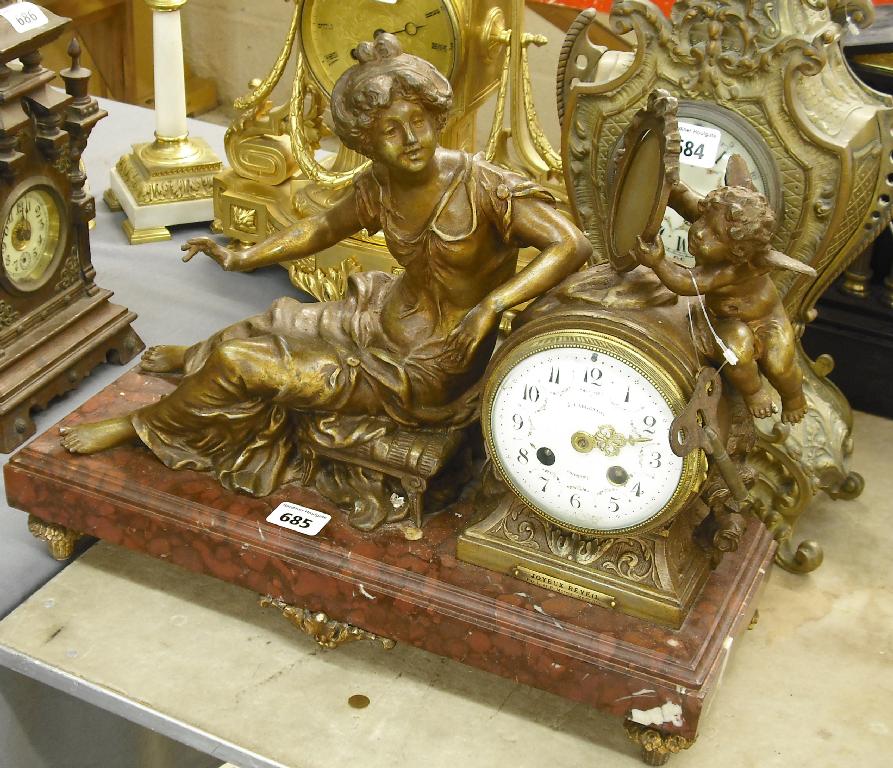 Appraisal: French red marble and spelter figural two train mantel clock