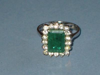 Appraisal: AN EMERALD AND DIAMOND DRESS RING with rectangular emerald mm