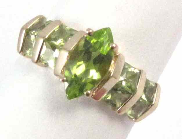 Appraisal: PERIDOT AND FOURTEEN KARAT GOLD RING set with a marquise-cut