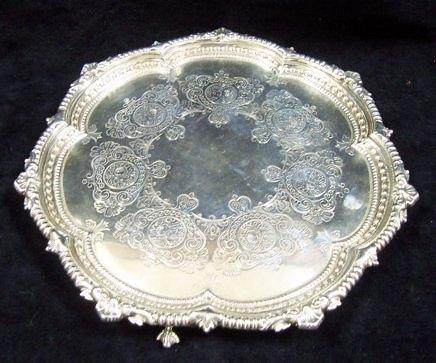 Appraisal: A salver with engraved decoration and beaded rim on three