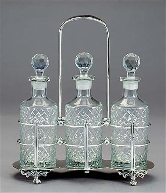 Appraisal: Silverplate caddy containing three crystal decanters metal hinged upside down