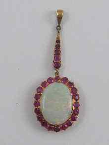 Appraisal: A yellow metal tests ct gold opal and ruby pendant