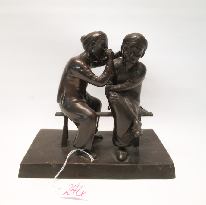 Appraisal: BRONZE FIGURAL GROUP depicting two seated Asian men one receiving