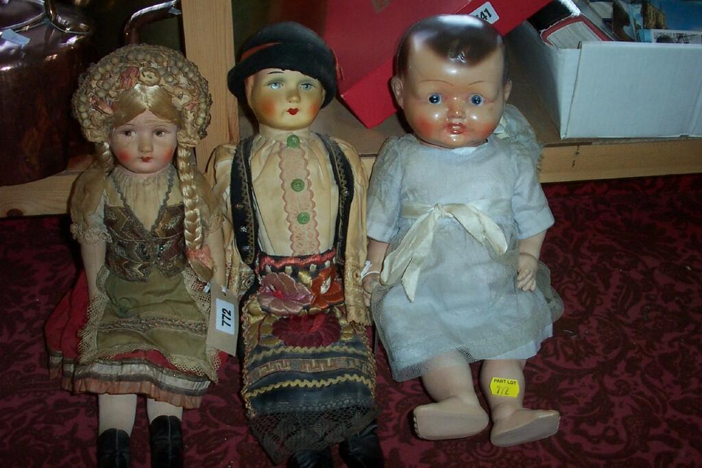 Appraisal: A pair of Tyrolean style dolls with moulded and painted