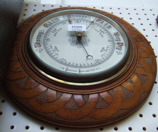 Appraisal: An oak cased aneroid barometer early th century the white