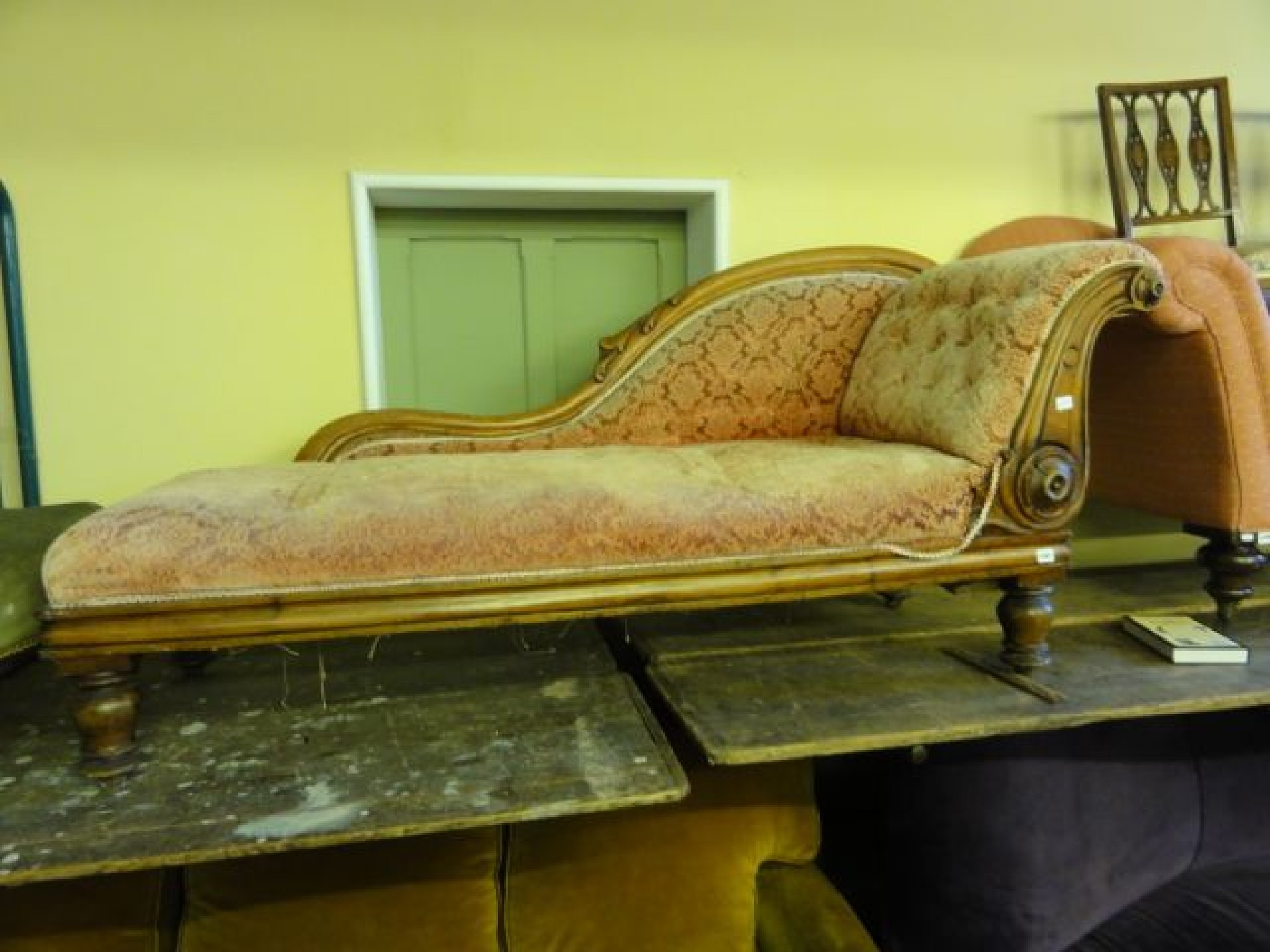 Appraisal: A mid Victorian chaise lounge with carved show wood detail