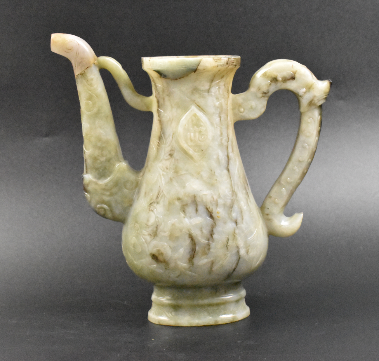 Appraisal: A Chinese celadon and russet jade carved ewer dating from