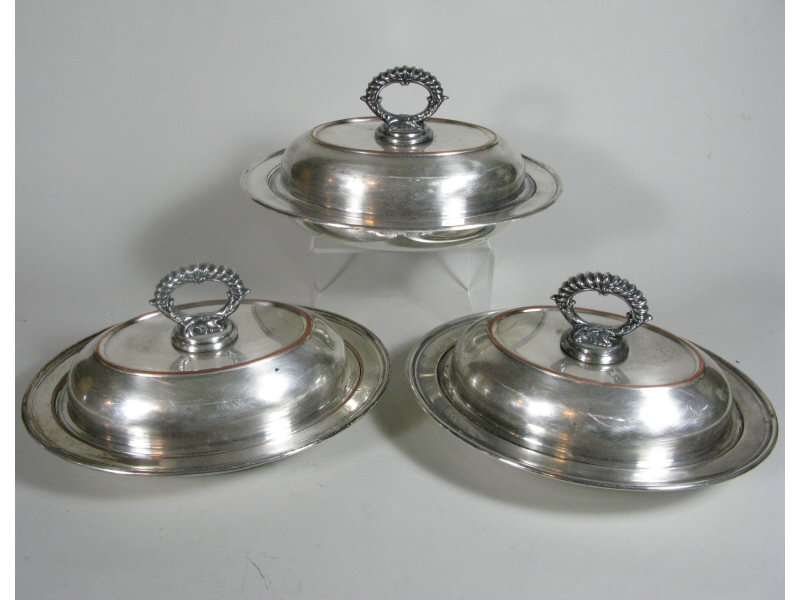 Appraisal: Three Silverplate Lidded Entr e Dishes English silver on copper