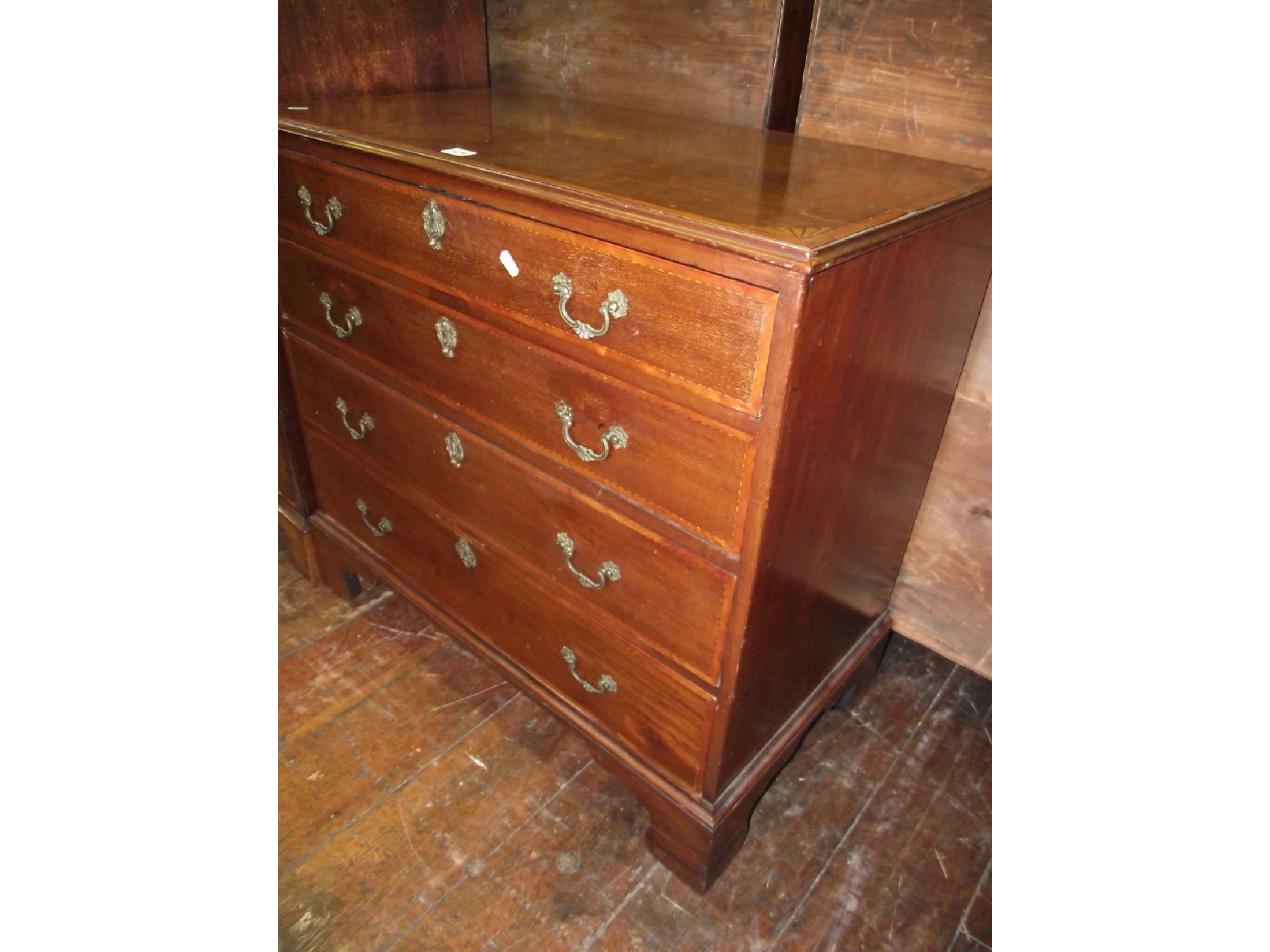 Appraisal: A small Georgian mahogany chest of four long graduated drawers