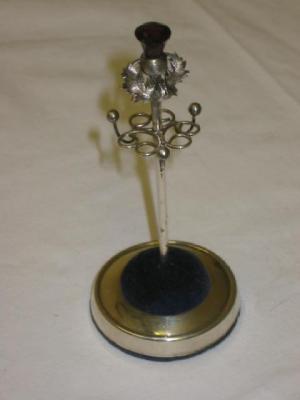 Appraisal: A HAT PIN RING STAND with amethyst glass thistle finial