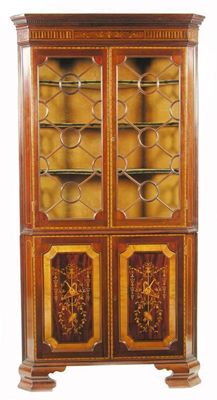 Appraisal: An Edwardian mahogany and marquetry standing corner cupboard having a