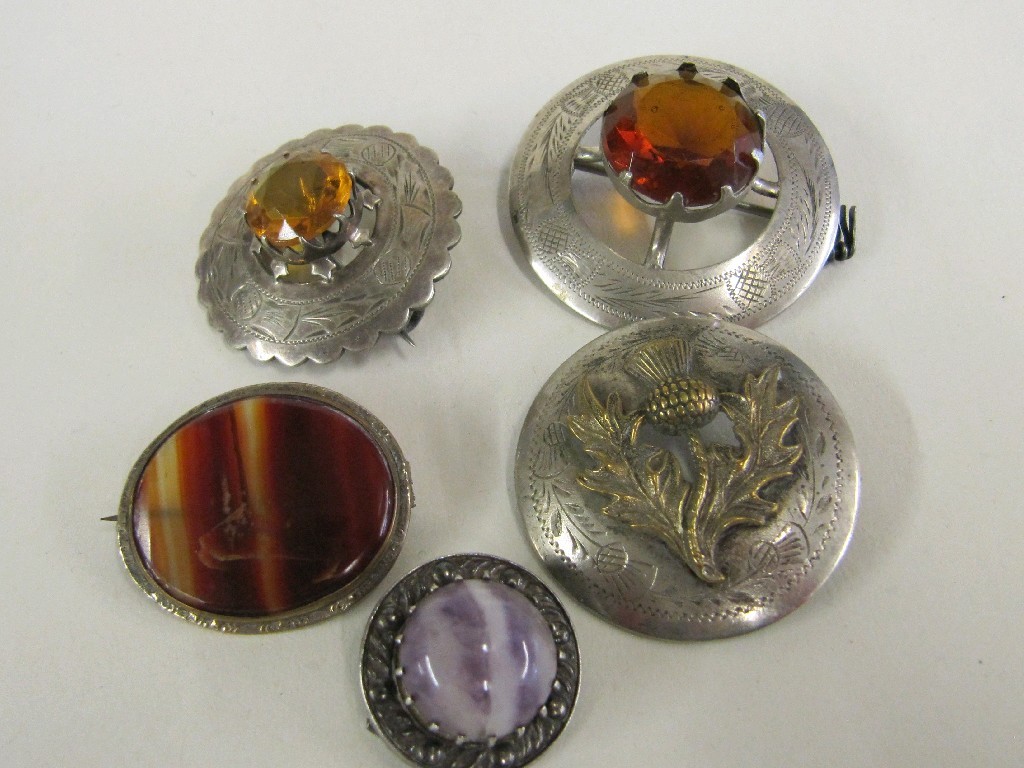 Appraisal: Lot comprising three thistle decorated Scottish brooches two with citrine