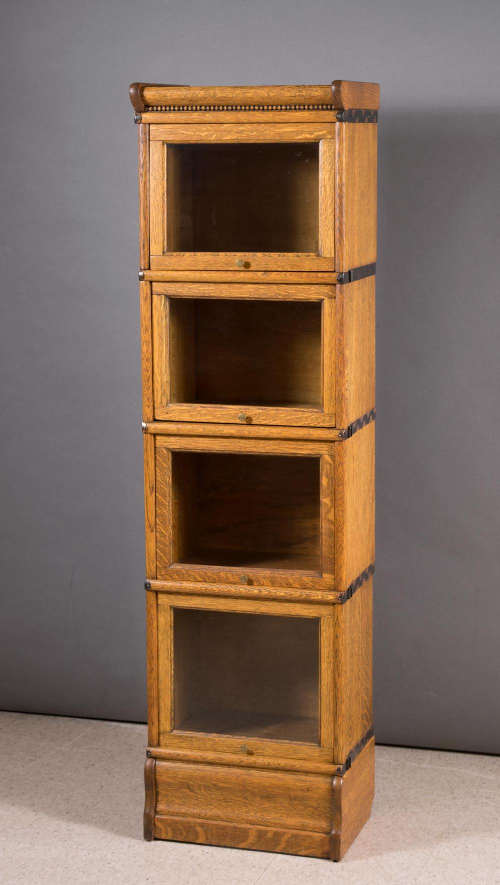 Appraisal: NARROW STACKING OAK BOOKCASE American early th century four stacking