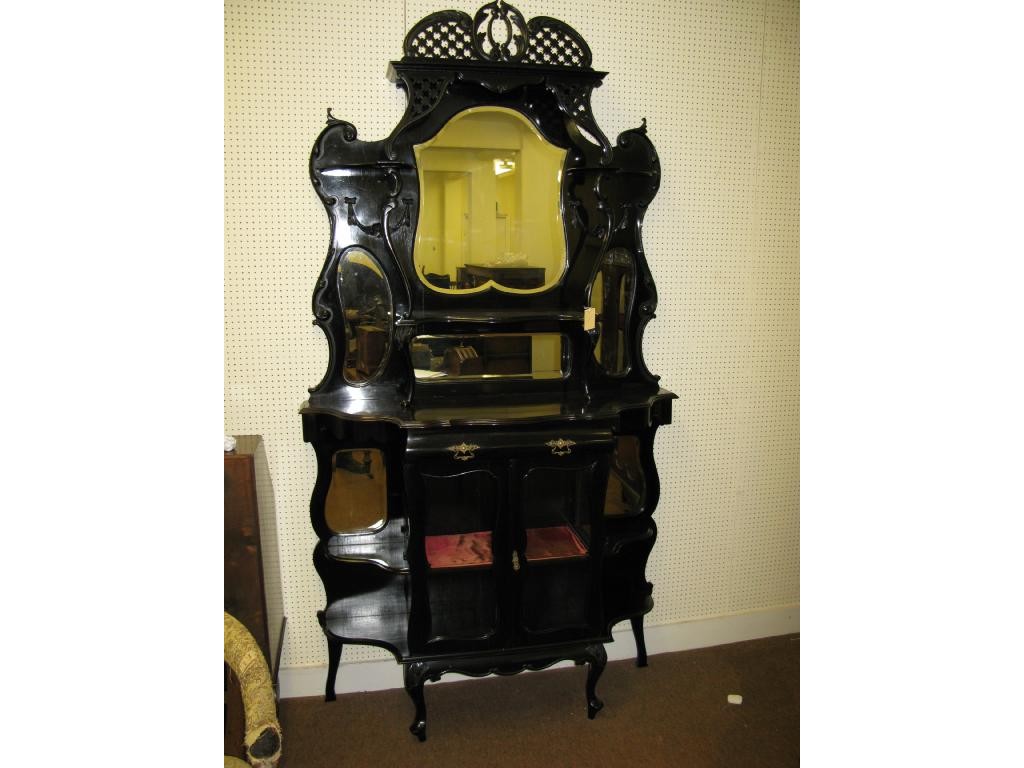 Appraisal: A late Victorian ebonised mahogany tall display cabinet bevelled mirror