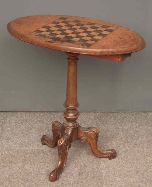 Appraisal: A Victorian walnut oval games table the burr walnut veneered