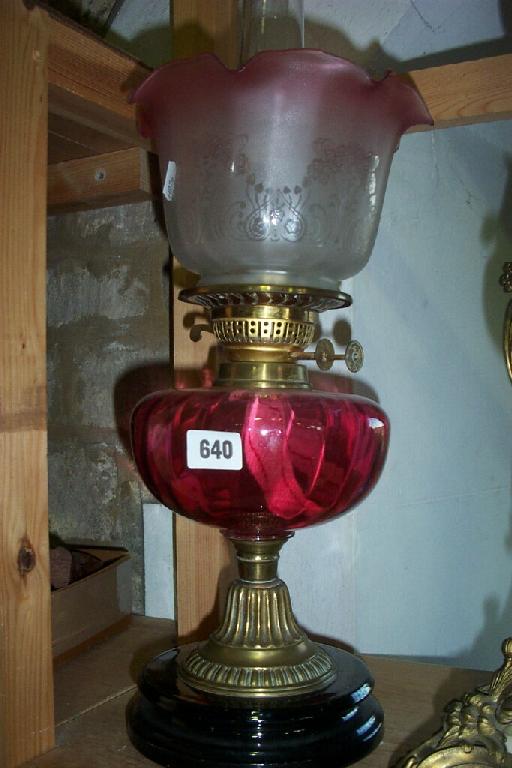 Appraisal: An early th century brass based oil lamp with a