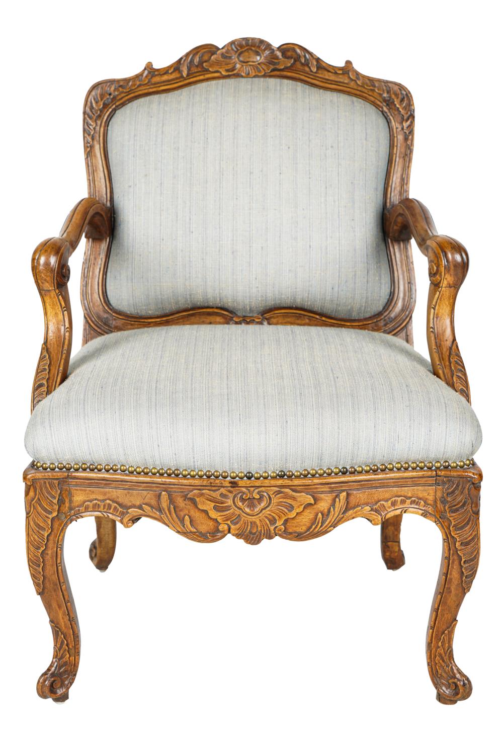 Appraisal: FRENCH PROVINCIAL FAUTEUILcarved walnut covered in light blue-grey fabric Condition