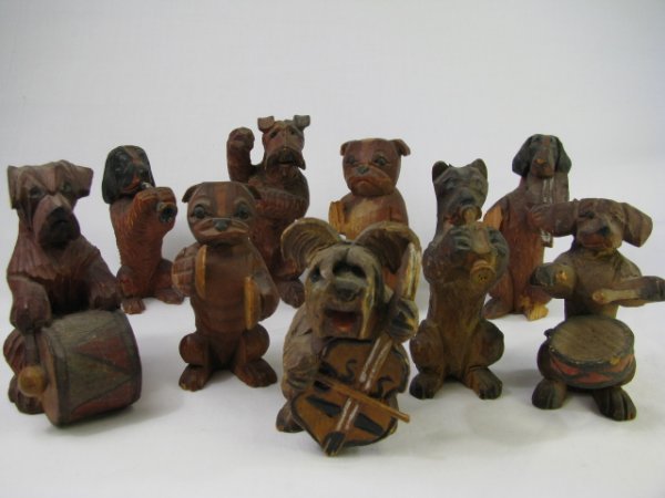 Appraisal: Nine piece miniature carved wood canine band with each dog