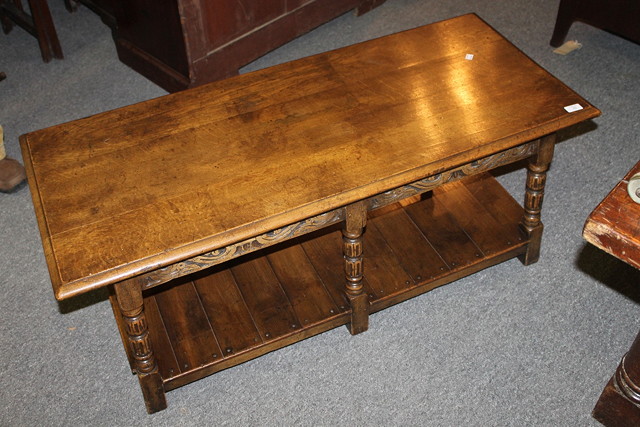 Appraisal: A CARVED OAK COFFEE TABLE with fluted supports