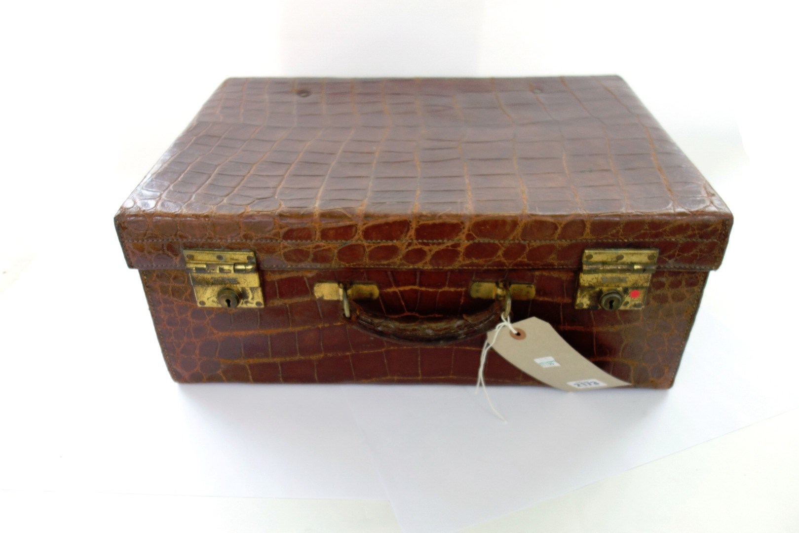 Appraisal: A brown crocodile skin suitcase early th century gilt lettered