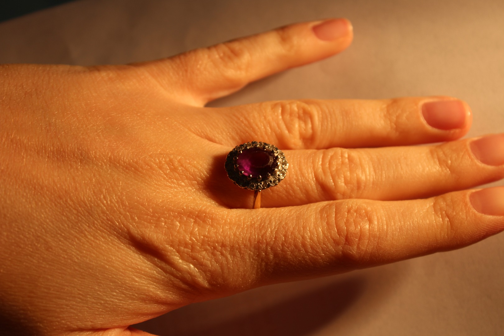 Appraisal: A vintage ct gold amethyst and diamond oval cluster ring