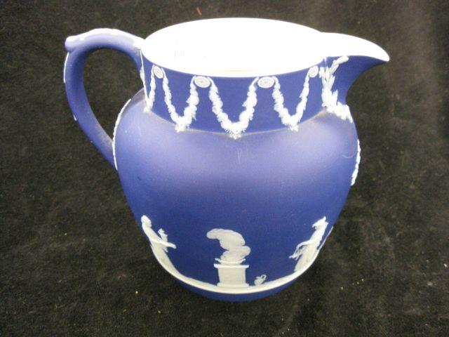 Appraisal: Wedgwood Dark Blue Jasperware Pitcher classical scenes excellent