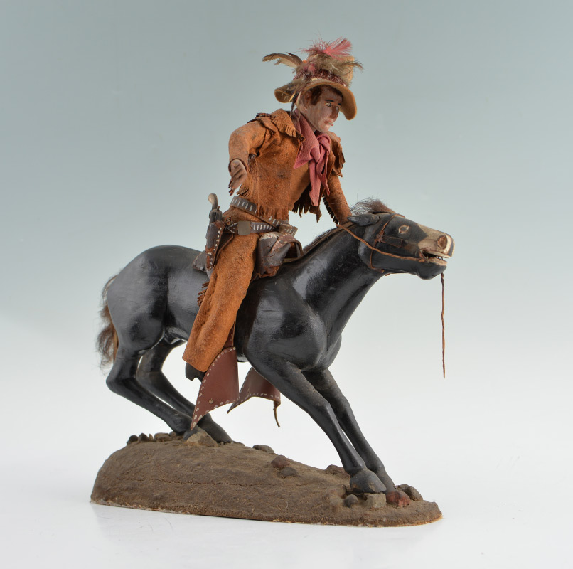 Appraisal: FOLK ART CARVED COWBOY ON HORSE Early th century nicely