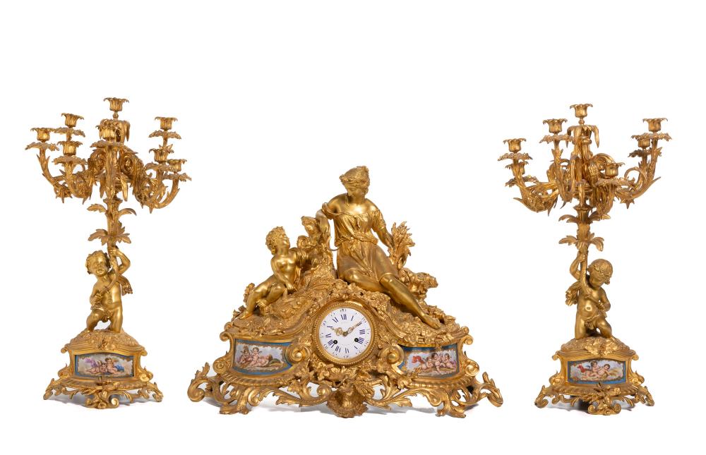 Appraisal: A gilt-bronze and porcelain mantel clock and candelabra set th