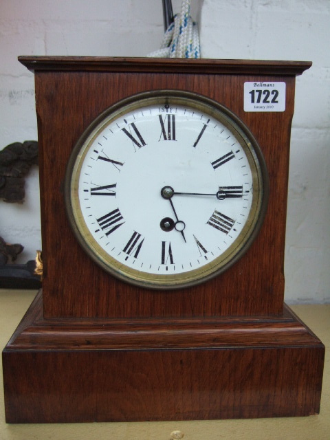 Appraisal: A Victorian oak cased mantel clock with white enamel dial