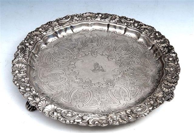 Appraisal: AN EDWARDIAN SILVER SALVER with shell and scroll border and