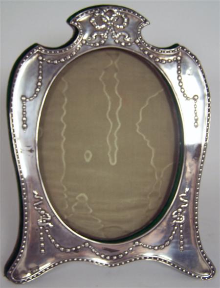 Appraisal: An Edwardian photograph frame Chester of shaped shield outline with