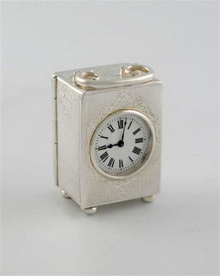 Appraisal: A modern mounted boudoir or carriage timepiece with an engine