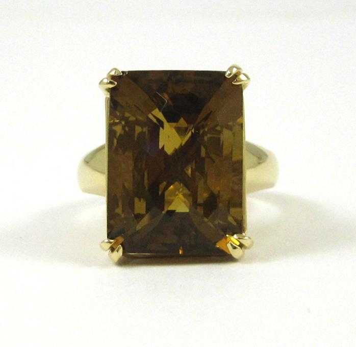 Appraisal: SMOKY CITRINE AND FOURTEEN KARAT GOLD RING set with a