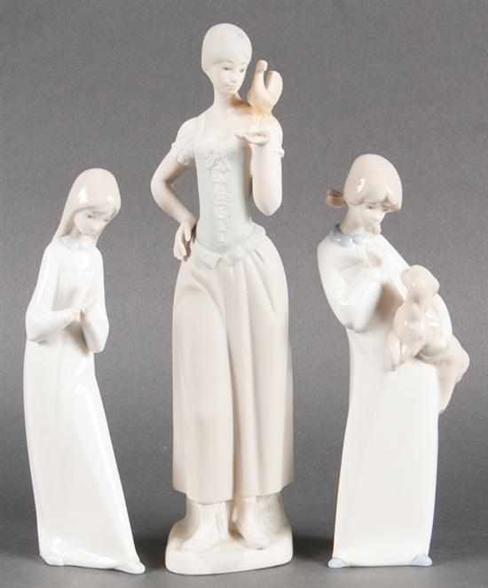 Appraisal: Two Lladro style porcelain figures and a similar bisque figure