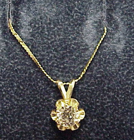 Appraisal: JEWELRY K yellow gold pendant set with one round brilliant