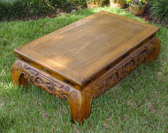 Appraisal: CHINESE PEACH WOOD COFFEE TABLE Carved and pierced apron curved