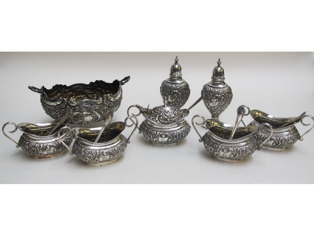 Appraisal: A Victorian silver embossed cruet set comprising mustard pot four