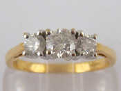 Appraisal: An carat gold three stone diamond ring accompanied by IGI