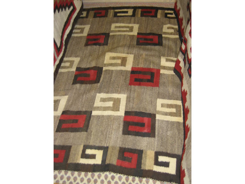 Appraisal: NAVAJO RUG The natural tan field shows a meandering geometric