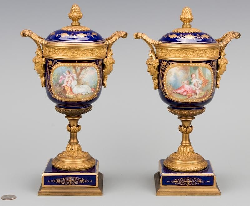 Appraisal: Pr Sevres Gilt Mounted Porcelain Urns Pair of Sevres gilt