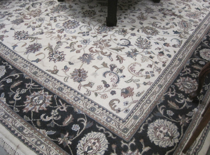 Appraisal: HAND KNOTTED ORIENTAL CARPET Indo-Persian Isfahan floral design on cream