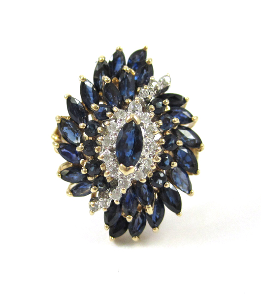 Appraisal: SAPPHIRE AND DIAMOND CLUSTER RING k gold set with marquise-cut