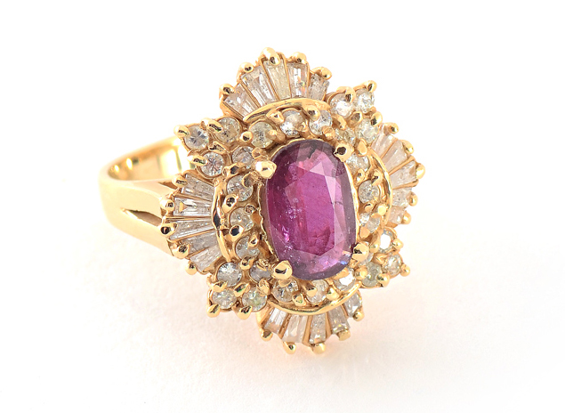 Appraisal: RUBY DIAMOND RING K yellow gold ring centers one oval